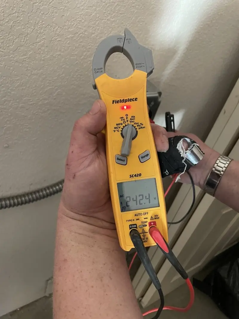 Voltage testing with clamp meter during Recessed Lighting Installation in Baltimore Highlands